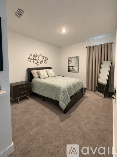 A bedroom with a large bed and a mirror on the wall.