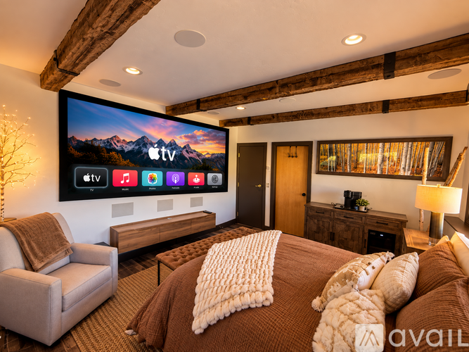 A modern living room with a large flat screen TV mounted on the wall.