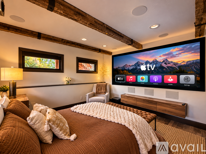 A bedroom with a large bed and a flat screen TV mounted on the wall.