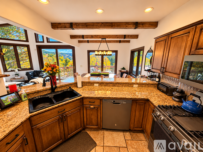 A kitchen with wooden cabinets and granite countertops.