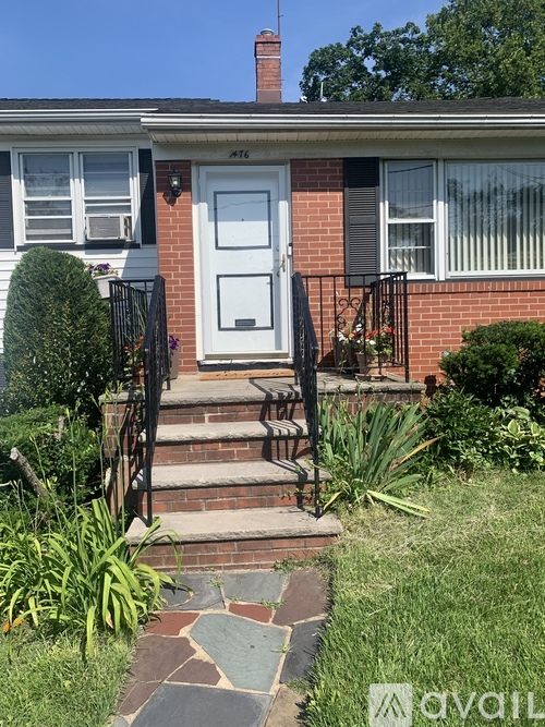 A brick house with a white door and a small front porch.