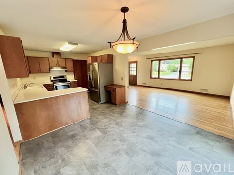 A kitchen with brown cabinets and a refrigerator.