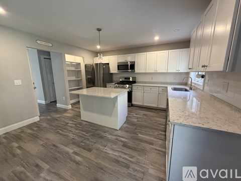 A kitchen with a large island in the middle.