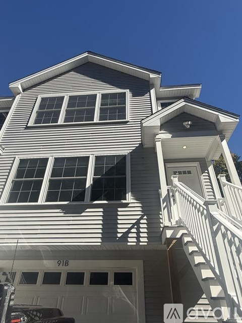 A two-story house with a garage and a white door.