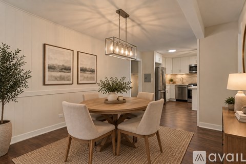 A dining room with a round table and chairs.