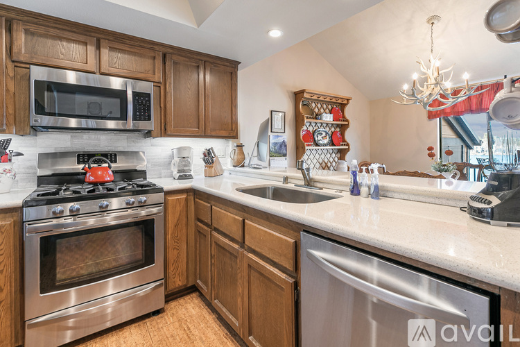 A kitchen with a stove top oven and a microwave above it.