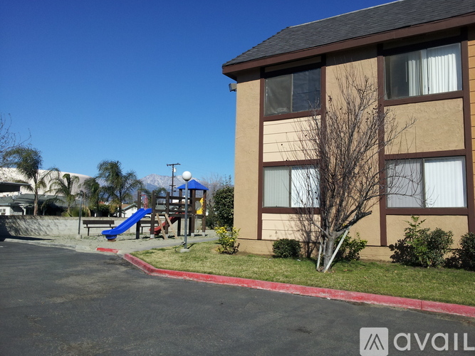 A building with a playground in front of it.