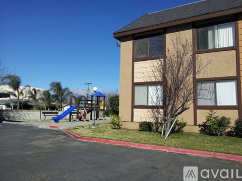 A building with a playground in front of it.