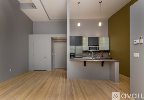 A kitchen area with a counter and cabinets.