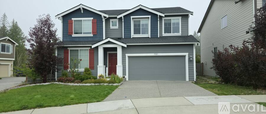 A two-story house with a garage is for sale.