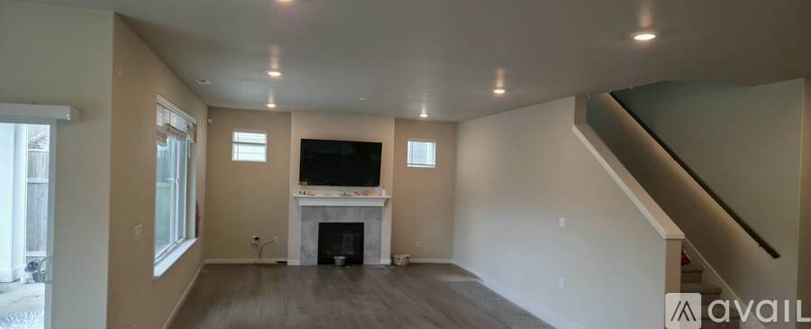 A living room with a fireplace and a television.