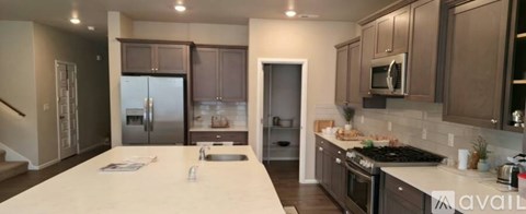 A kitchen with brown cabinets and a white countertop.