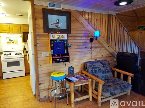 A living room with a TV and a chair.