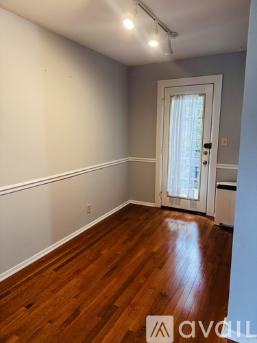 A room with wooden floors and a white door.