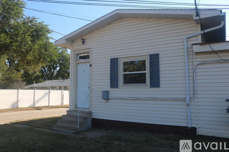 A small white house with a window and a door.