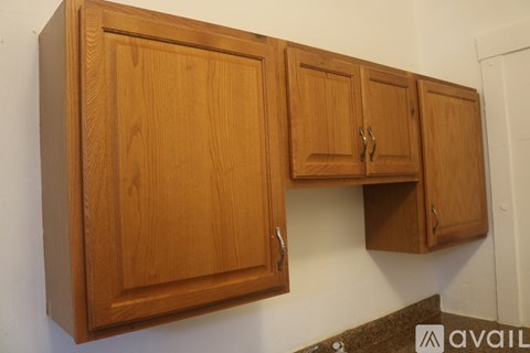 A brown wooden cabinet with a drawer and a cupboard on top of it.