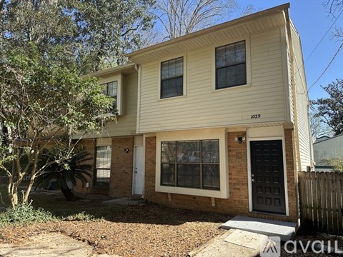 A two-story house with a garage is for sale.