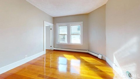 A room with a wooden floor and a window.