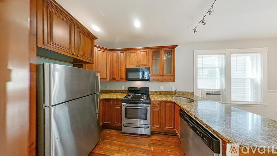 A kitchen with wooden cabinets and stainless steel appliances.