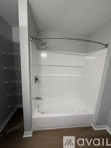 A white bathroom with a tub and a shower.