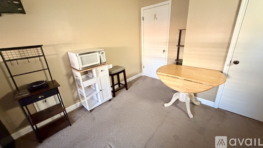 A small kitchen with a microwave, oven, and sink.