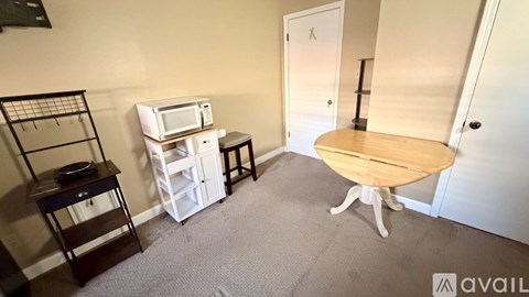 A small kitchen with a microwave, oven, and sink.