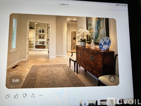 A room with a wooden dresser and a painting on the wall.