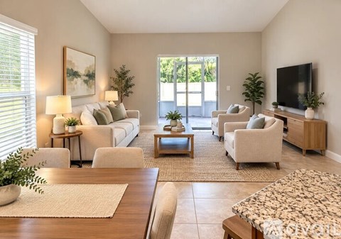 A living room with a couch, chairs, and a television.