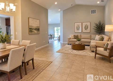 A living room with a dining table and chairs.