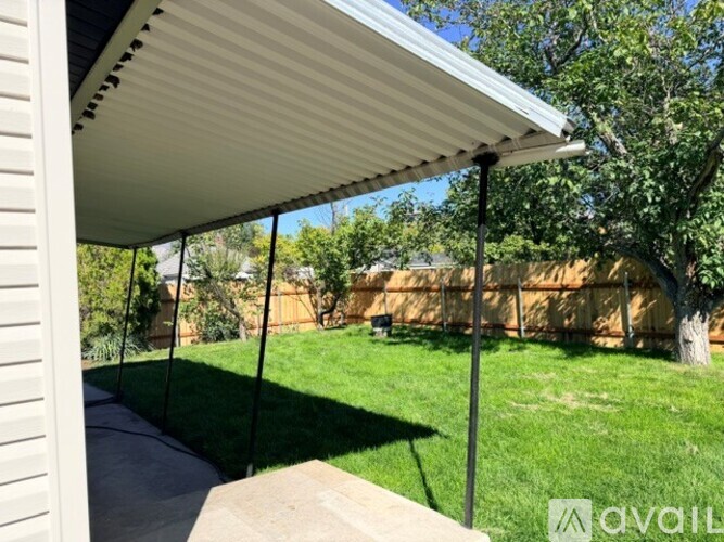 A patio with a white awning over it.