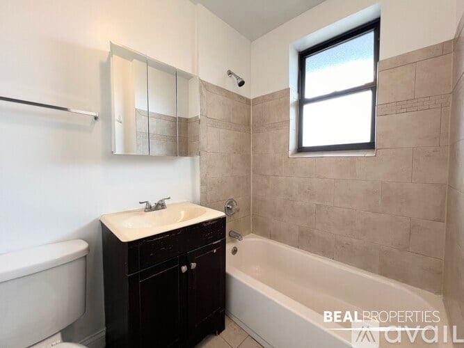 A bathroom with a white sink and a bathtub.