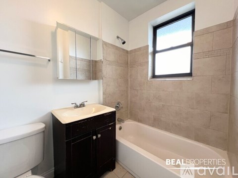 A bathroom with a white sink and a bathtub.