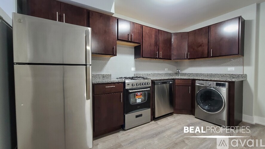 A kitchen with brown cabinets and a stainless steel refrigerator.