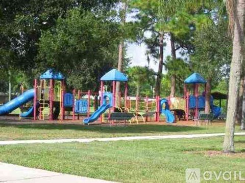 A playground with a blue slide and a red slide.