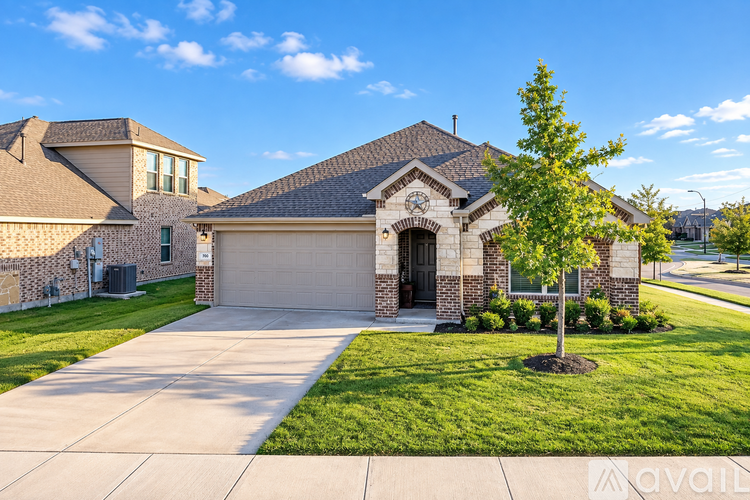 A house with a driveway and a tree in front.