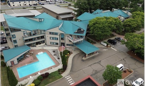 A large building with a pool in the middle of it.