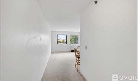 A room with a chair and a window.