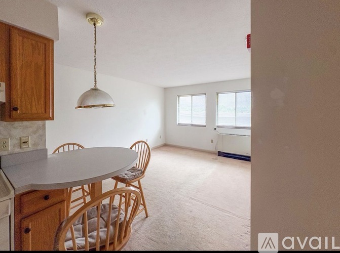 A kitchen with a table and chairs is available for rent.