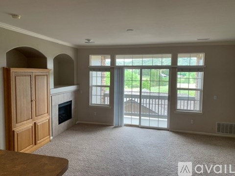 A living room with a fireplace and sliding glass doors.