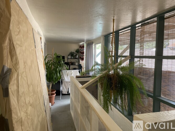 A long hallway with a table and chairs in the distance.
