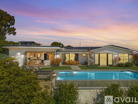 A modern house with a swimming pool in the backyard.