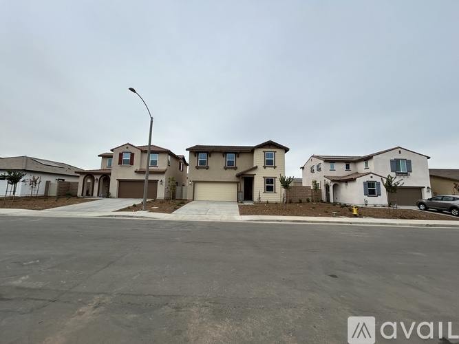 A row of houses with a car parked in front of the first one.