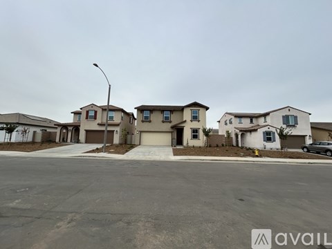 A row of houses with a car parked in front of the first one.
