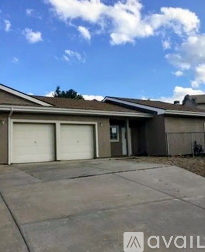 A house with a garage and a driveway in front.