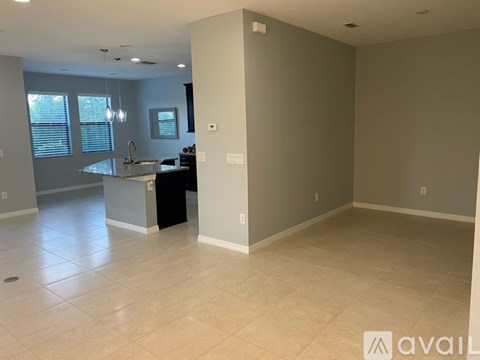 A kitchen area with a sink and a window.
