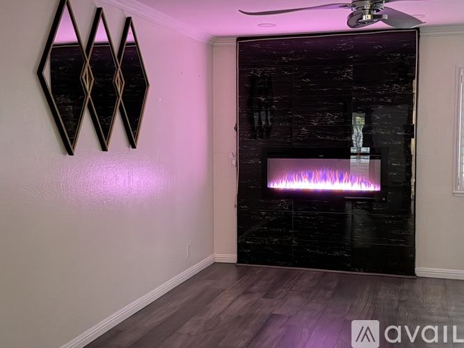 A room with a purple light and a fireplace.