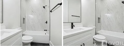 A bathroom with a marble wall and a white tub.