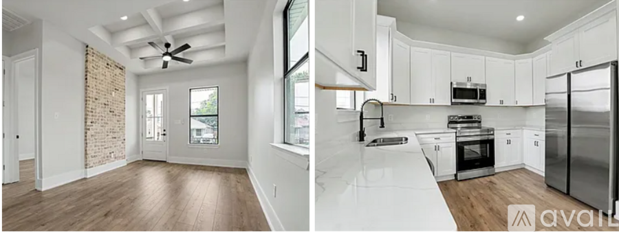 A modern kitchen with white cabinets and a refrigerator.