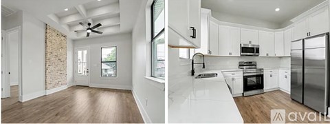 A modern kitchen with white cabinets and a refrigerator.