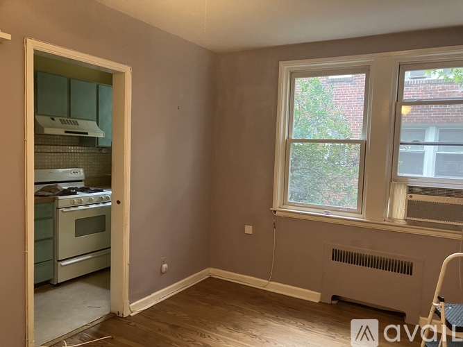 A room with a window and a wall heater.